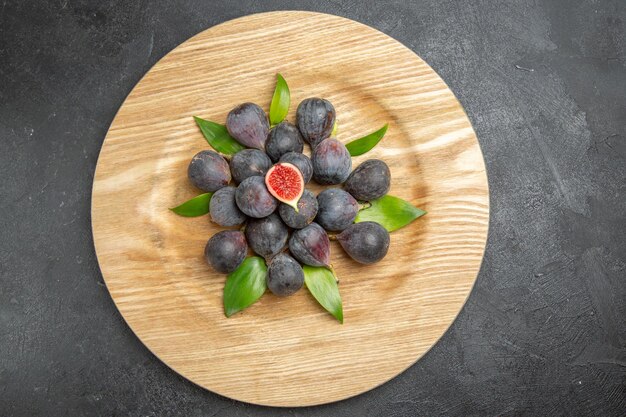 Top view fresh sweet figs inside plate on dark background