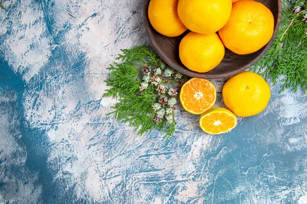 Top view fresh tangerines on light-blue background