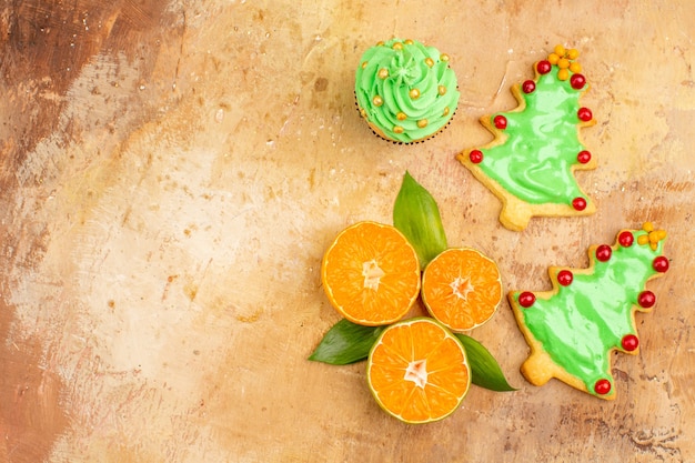 Top view fresh tangerines with cakes