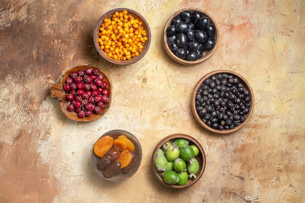 Free photo top view of fresh various fruits in small brown pots