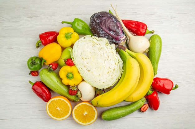 Top view fresh vegetable composition with fruits on white background