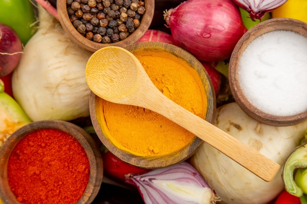 Top view fresh vegetable composition with seasonings on white table