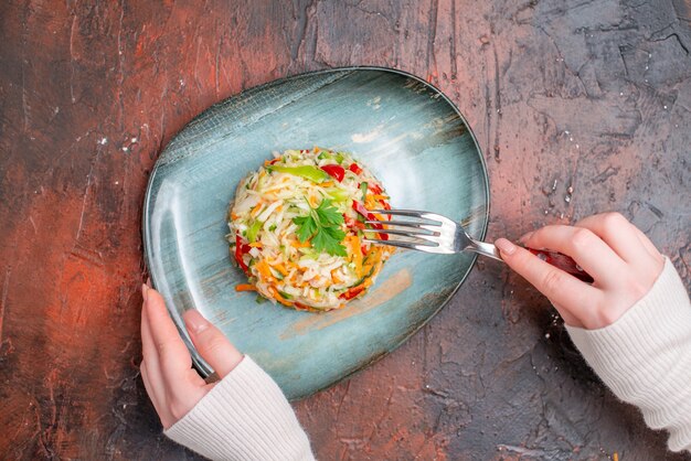 Top view fresh vegetable salad inside plate on dark table