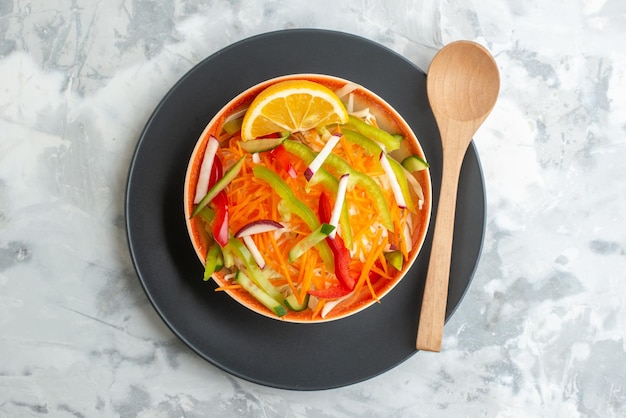 Top view fresh vegetable salad inside plate with wooden spoon on white surface food meal diet horizontal dinner health