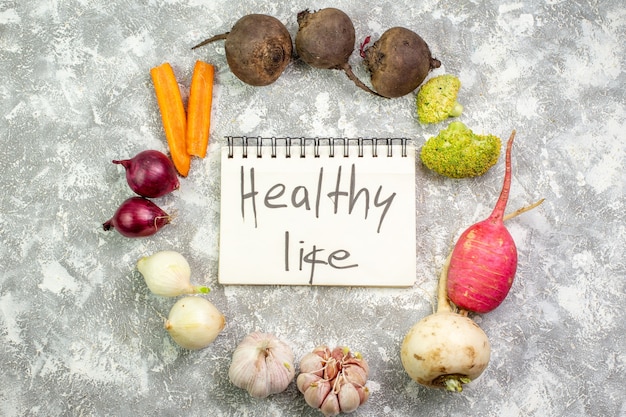 Free photo top view fresh vegetables beet radish garlic and onions on the white table