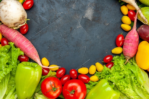 Top view fresh vegetables cherry tomatoes cumcuat radish bell peppers lettuce free space