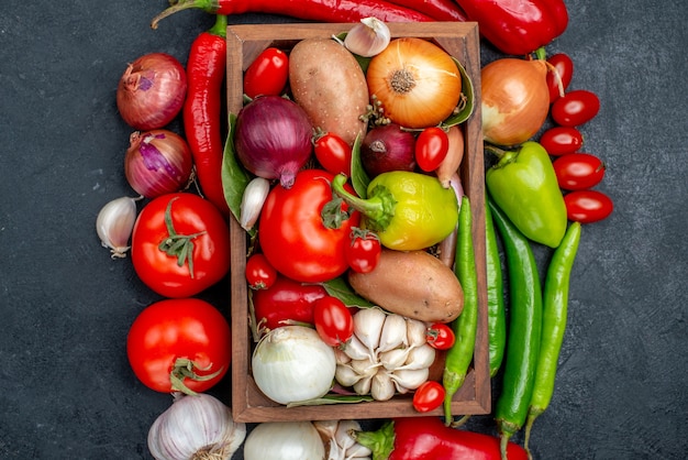 Top view fresh vegetables composition on a dark-grey table salad fresh color