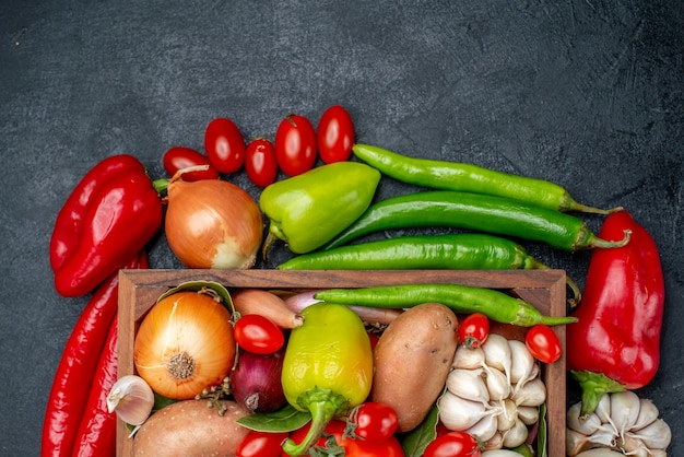 Top view fresh vegetables composition on grey table salad ripe color