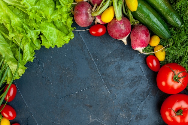 Top view fresh vegetables tomatoes radish cucumber dill cherry tomatoes lettuce on dark surface with copy place