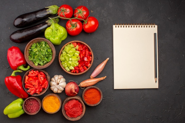 Top view fresh vegetables with greens and different seasonings on grey background meal salad health food vegetables