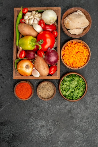 Top view fresh vegetables with salad ingredients on dark floor