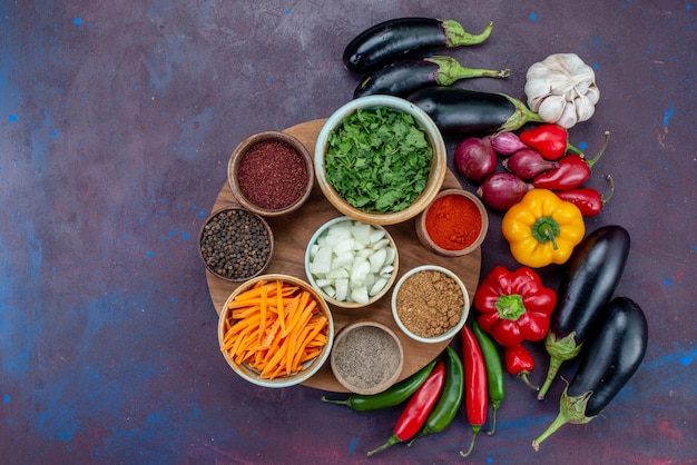 Top view fresh vegetables with seasonings and greens on the dark desk salad meal vegetable