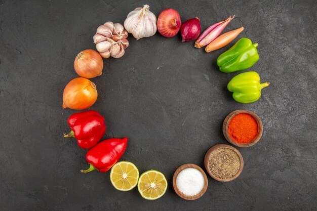 Free Photo top view fresh vegetables with seasonings on a grey background