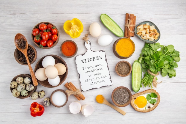 Free Photo top view fresh white eggs with vegetables and seasonings on a white background food color ripe lunch salad breakfast