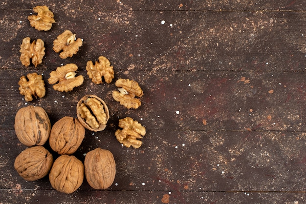 Top view fresh whole walnuts raw on brown