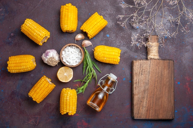 Top view fresh yellow corns raw with oil on a dark surface corn snack food raw fresh