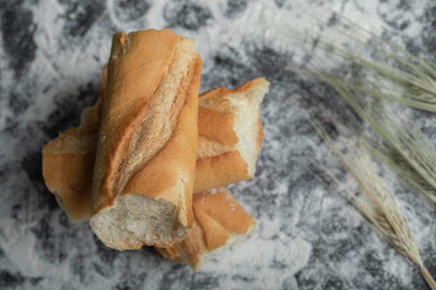 Top view of Freshly baked baguette slices on white background.