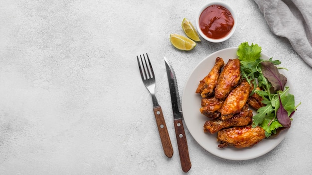 Free photo top view of fried chicken on plate with salad and sauce