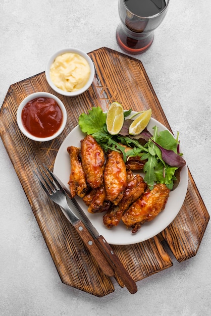 Free Photo top view of fried chicken on plate with sauce and fizzy drink