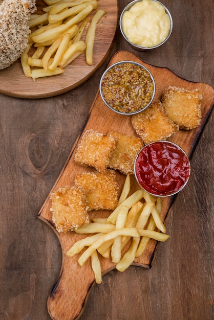 Free photo top view of fried chicken with french fries and different types of sauce