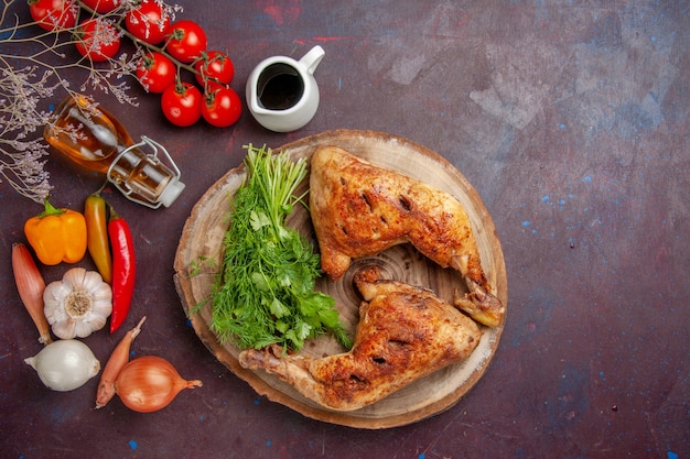 Top view fried chicken with greens and vegetables on dark space