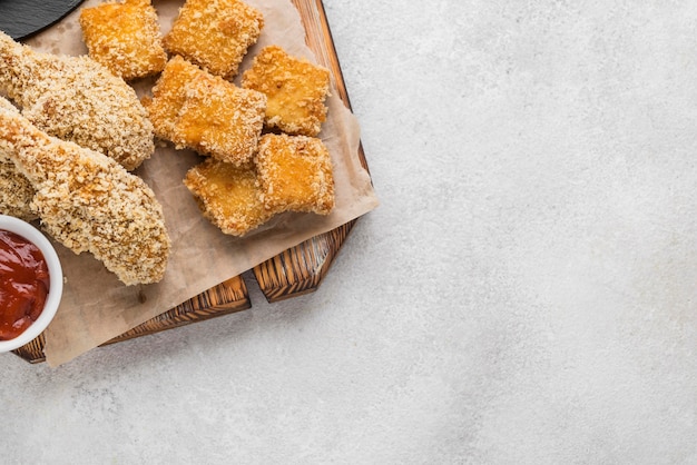 Top view of fried chicken with nuggets and copy space