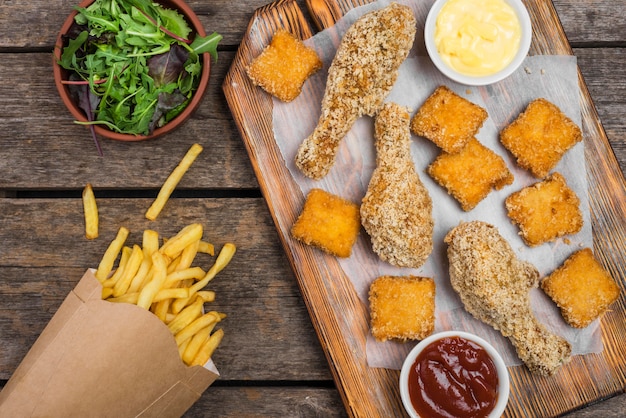 Free photo top view of fried chicken with salad and french fries