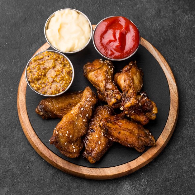 Top view of fried chicken with variety of three sauces