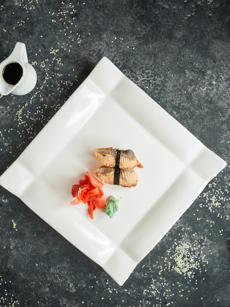 Free Photo top view of fried fish nigiri served with ginger and wasabi