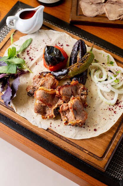 A top view fried meat bones with fried vegetables and sauce on the table food meal dinner restaurant