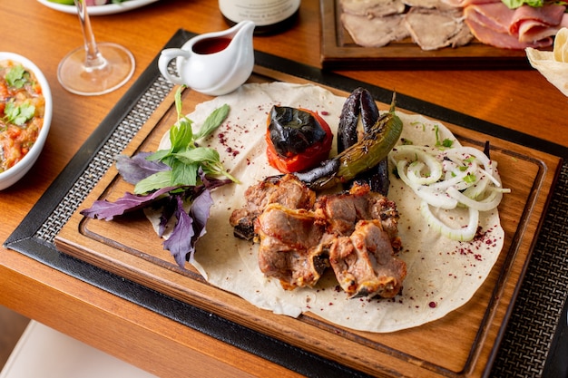 A top view fried meat with fried vegetables leaves and sauce on the table food meal dinner restaurant