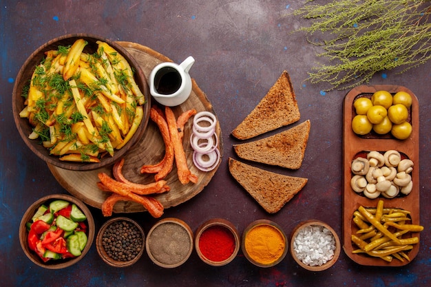 Free Photo top view fried potatoes with seasonings bread and different vegetables on dark surface