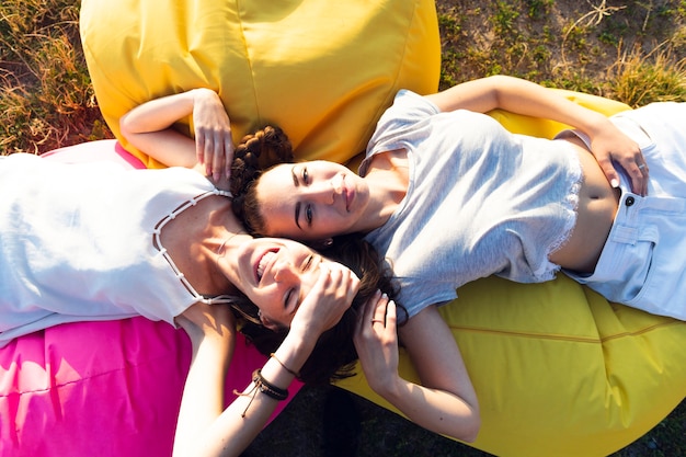 Top view friends relaxing on beanbags 