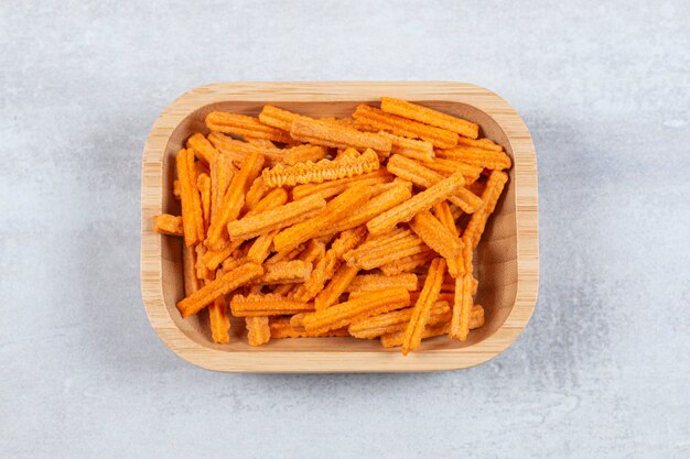 Top view of fries crisp in wooden bowl.