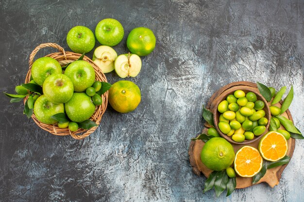 Top view from afar apples the board with citrus fruits basket of apples