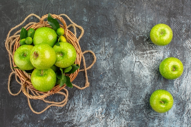 Free photo top view from afar apples rope basket of apples with leaves on the table