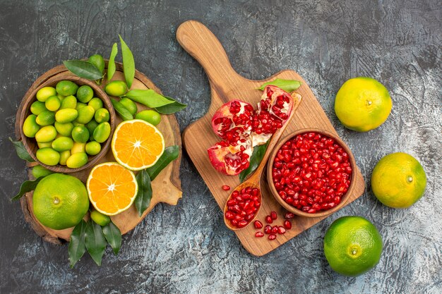 Top view from afar citrus fruits oranges mandarins pomegranate seeds on the board