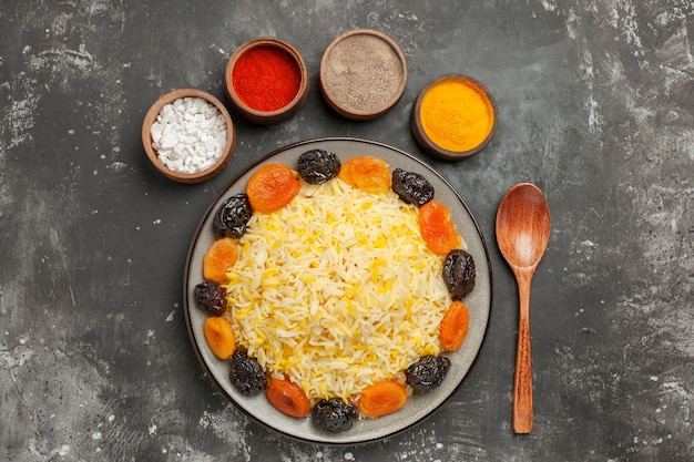 Free Photo top view from afar rice spoon bowls of colorful spices rice with dried fruits