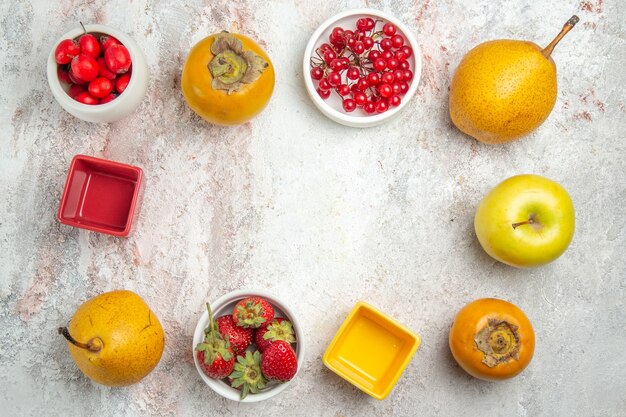 Top view fruit composition different fresh fruits on white table color ripe