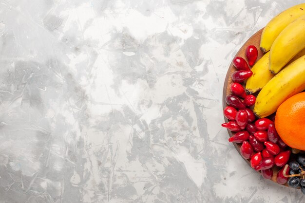 Top view fruit composition fresh bananas dogwoods and grapes on white desk fruits berry freshness vitamine