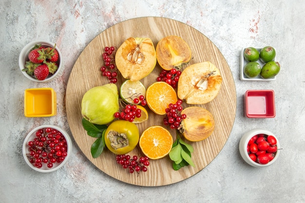 Free photo top view fruit composition fresh fruits on white floor