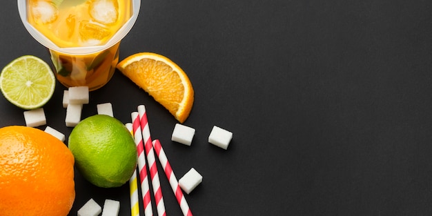 Free Photo top view of fruit juice in cups with straws