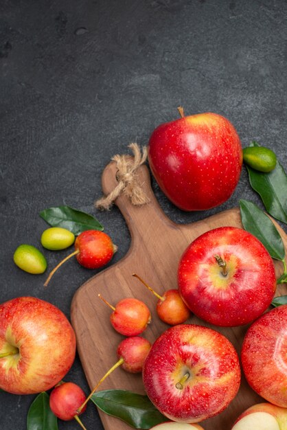 Top view fruits citrus fruits next to the apples yellow-red berries on the board