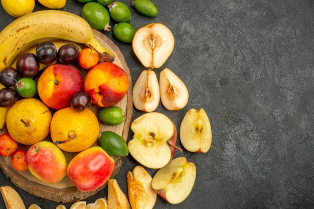 Top view fruits composition fresh fruits on a grey background