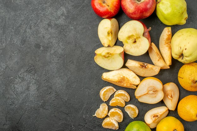 Top view fruits composition fresh ones on dark background