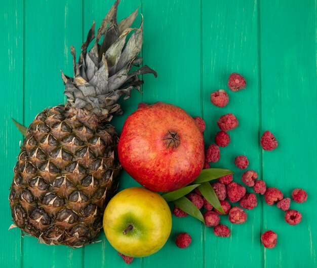 Top view of fruits on green surface