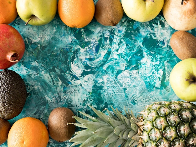 Free photo top view of fruits on wooden background. copyspace available