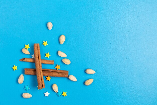 Top view ful sweet candies star shaped with cinnamon on the blue background