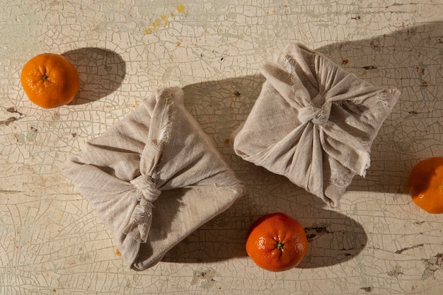 Free photo top view furoshiki package and oranges