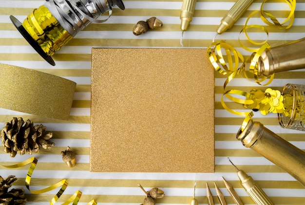 Free photo top view gift box surrounded by golden ribbons and sequins